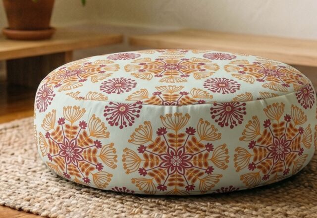 Close-up of the Bagh Medallion cushion's block-printed marigold motif