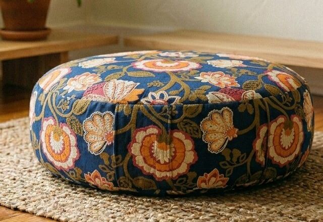 Close-up of the Indigo Bloom cushion's block-printed marigold pattern